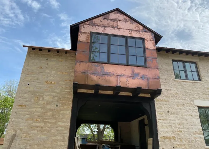 Copper metal panel facade on a stone building for Skylight Installation in Joliet