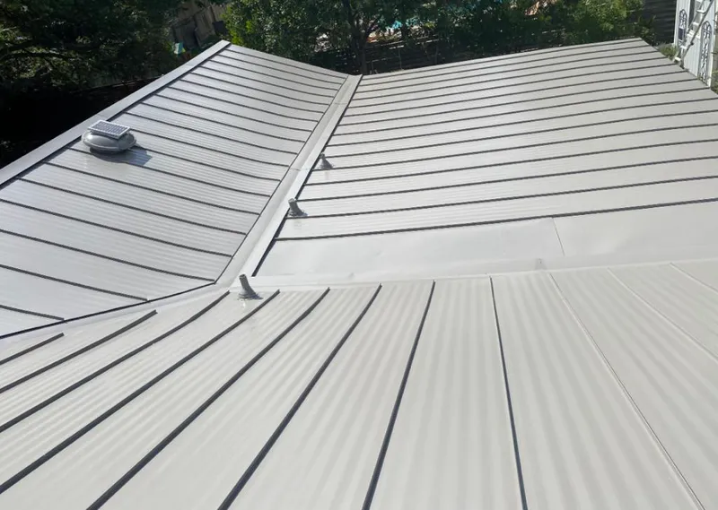Solar attic fan installed on a metal roof for Roof Ventilation in Joliet